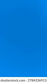 pure solid blue sky gradient on a bright sunny morning, clean and unadulterated nature background. 