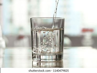 Pure Water Is Poured Into A Glass Beaker.