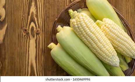 Pure white corn on a wooden table.