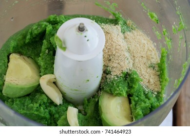 Pureed Broccoli, Avocado, Garlic And Nutritional Yeast In The Bowl Of A Food Processor