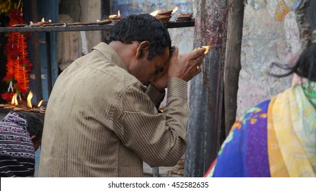 PURI, INDIA - 29 MAY, 2016: An Unidentified Indian Poor Man Praying Outside Indian Temple.