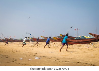 Puri, India - Circa January, 2018. Kids Playing Cricket On The Sandy Beach With Fishing Boats On The Background In Puri.