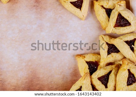 Purim background with cookies on old parchment paper.