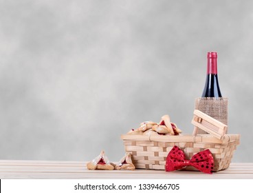 Purim Background With Wooden Table, Hamantaschen Wine And Gragger