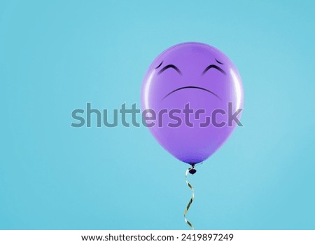 Purple balloon with sad face on light blue background. Space for text