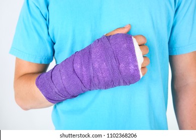 Purple Bandage On The Broken Hand Of A Teen