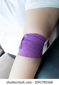 Purple Bandage Wrapped Around The Wounded Elbow - Blood Donation Concept