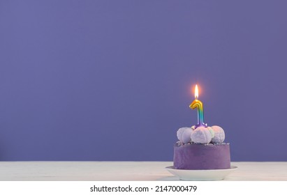 Purple Birthday Cake With Burning Candles On Purple  Background