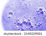 Purple blonde dye hair shampoo texture isolated on white background. Foam of violet cooling shampoo for blonde hair.