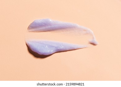 Purple Blonde Dye Hair Shampoo On Beige Background. Swatch Of Cooling Shampoo Or Conditioner For Blonde Hair.