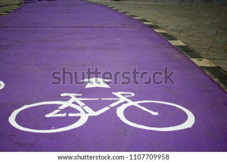 Purple bycicle road with sign