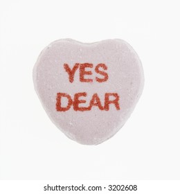 Purple Candy Heart That Reads Yes Dear Against White Background.