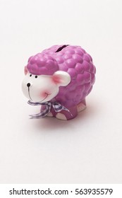 Purple Ceramic Piggy Bank On A White Background Lamb