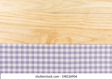 Purple Checkered Table Cloth On A Wooden Background