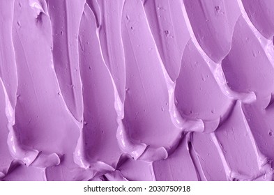 Purple clay (alginate face mask, body wrap, hair shampoo, conditioner) texture close up, selective focus. Abstract lavender background with brush storkes.