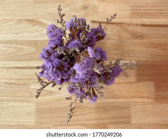 Purple Close Up From Bird Eye View Interior Decoration Flower With Light Colored Wooden Table As A Background.