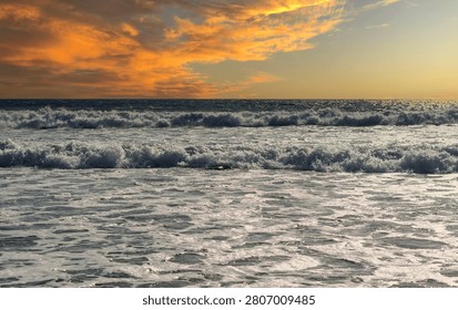 Purple clouds are reflected in the immense mirror of the sea