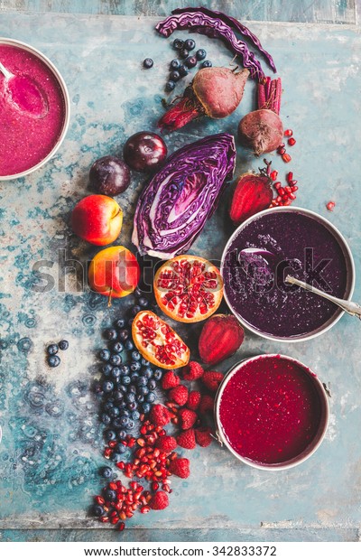 Purple color food collage. Pomegranate grapefruit\
raspberries, blueberries beet smoothie recipe. Mix vegan acai bowl\
food concept. rustic\
style.
