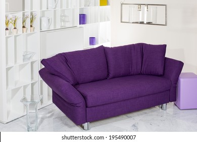 Purple Couch In Front Of White Wall Unit