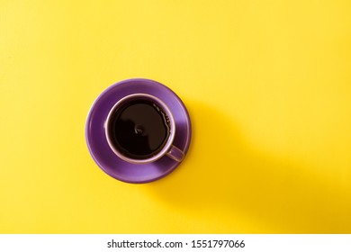 Purple Cup Of Coffee On The Yellow Background