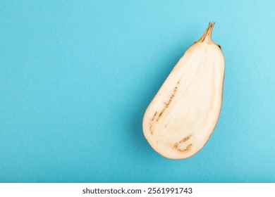 Purple Cutted eggplant on blue pastel background. Top view, flat lay, copy space. Tropical, healthy food, vegetable, slice, minimalism. - Powered by Shutterstock