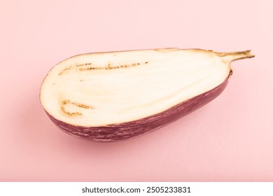 Purple Cutted eggplant with white stripes on pink pastel background. Side view, copy space. Tropical, healthy food, vegetable, slice, minimalism. - Powered by Shutterstock