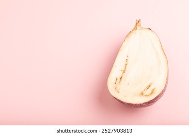 Purple Cutted eggplant with white stripes on pink pastel background. Side view, copy space. Tropical, healthy food, vegetable, slice, minimalism. - Powered by Shutterstock