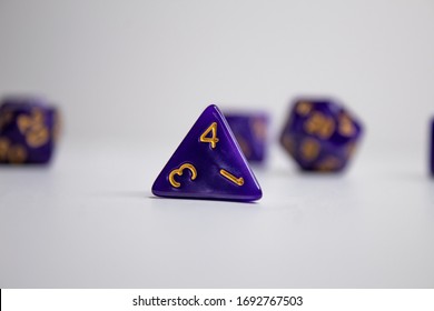 Purple dice set often used to play tabletop games such as Dungeons and Dragons or Magic the Gathering. The foremost dice is the D4 commonly used as a token to keep track of things during the game.