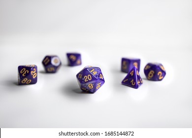 Purple dice set. These sets are often used to play table top games such as Dungeons and Dragons or Magic the Gathering. The D20 dice is show most prominent as its one of the most widely used. 
