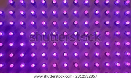 purple Disco wall background in neon led dot lighting.pipes and lamps on the wall. light bulbs pattern.LED decoration lights idea on wall.modern decoration.