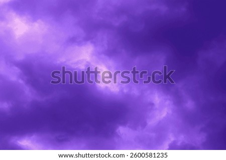 Purple dramatic stormy sky background. Dark fluffy cloudy sky. Halloween spooky moody scary cloudscape background concept.