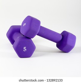 Purple Dumbells On White Two 5 Pound Weights On A White Background With Copy Space