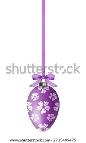 Purple Easter egg with pattern hanging on ribbon against white background