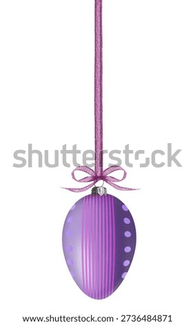 Purple Easter egg with pattern hanging on ribbon against white background