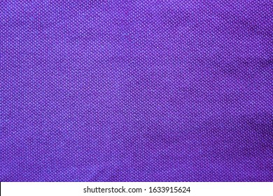 Purple Fabric Texture Of Empty Shirt Element. Blank Cotton Cloth Background, Colorful Dark Blue Surface Of Rough Jacket Material 