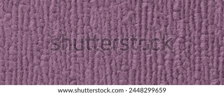 Purple fluffy background of soft, fleecy cloth. Texture of textile closeup.