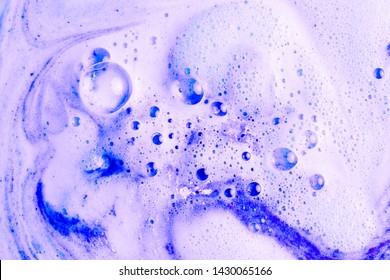 Purple foam after dissolving color bath bomb in water