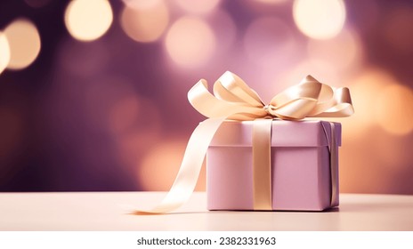 a purple gift box with a gold ribbon and a bow on a table with boke of lights in the backgroup of the room in the background - Powered by Shutterstock