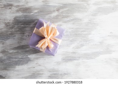 Purple Gift Box On White Wooden Background