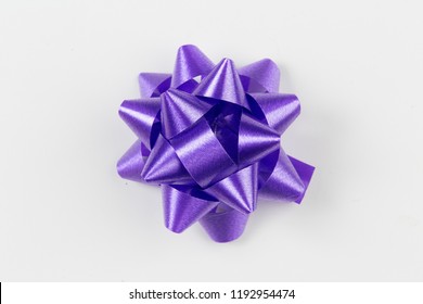 Purple Gift Wrap Bow Top View On White Background