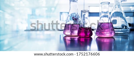 purple glass flask in blue research chemistry science banner laboratory background 