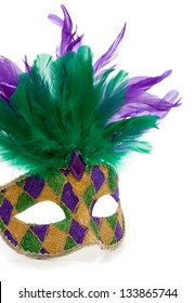 A Purple, Gold And Green Mardi Gras Mask With Feathers On A White Background