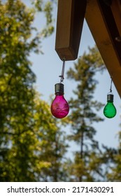 Purple And Green Bulb Hung On Roof Boards. Decor Of The Sauna House. For Better Night Vision.