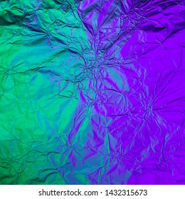 Purple green crumpled background made of illuminated foil. Trendy duotone texture.