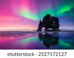 Purple and green Northern lights over Basalt stack Hvitserkur on the Vatnsnes peninsula, Iceland. Gorgeous Icelandic landscape with Polar lights. Aurora Borealis