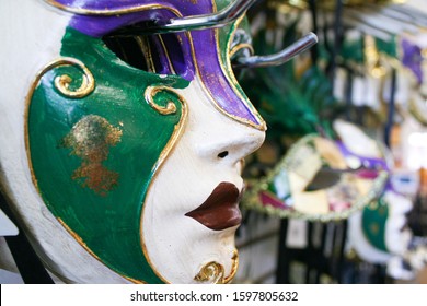 A purple, green and white Mardi Gras carnival mask available for sale at a stand catering to tourists in downtown New Orleans, Louisiana. - Shutterstock ID 1597805632