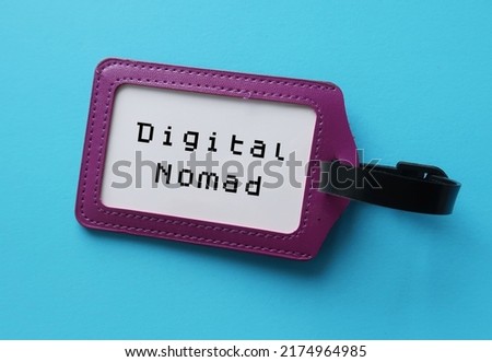 Purple ID card holder on blue background with with job title DIGITAL NOMAD, refers to people who conduct nomadic life by doing remote work from anywhere using digital telecommunications technology
