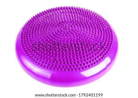 Purple inflatable balance disk isoleated on white background, It is also known as a stability disc, wobble disc, and balance cushion.