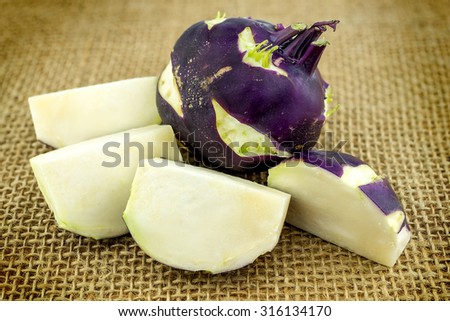 Purple kohlrabi slices on hessian burlap background