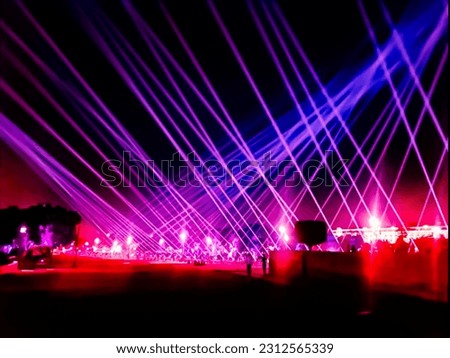 Purple laser neon beams club stage Luxury entertainment with audience silhouettes in nightclub event, Beams and rays shining colorful lights.